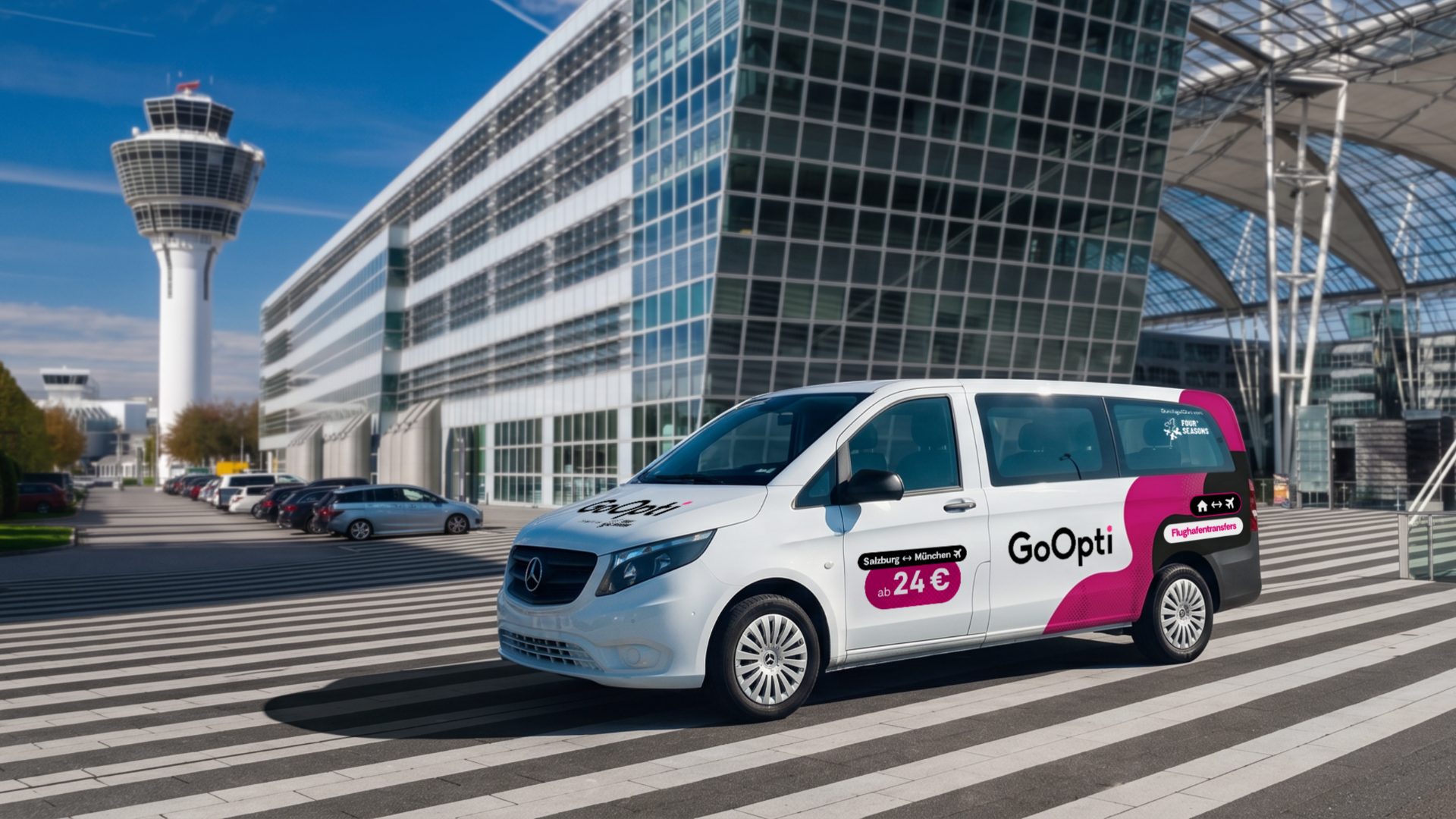 GoOpti-Van am Flughafen München, dahinter Tower und Terminal